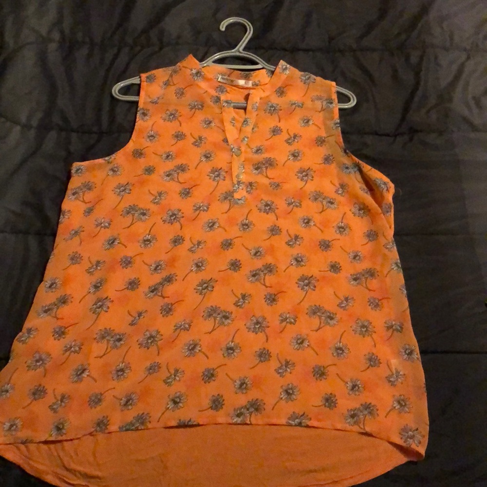 Orange sleeveless top.